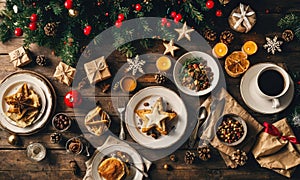 A table full of food is decorated with Christmas ornaments and star shaped food items.