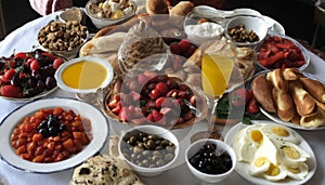 A table full of food, including fruit, bread, and eggs