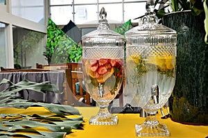 Sobre a mesa jarros de vidro com ÃÂ¡gua aromatizada com frutas diversas photo