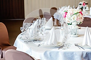 Table with glasses and napkins served for dinner in restaurant