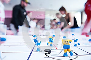 Table hockey game with player on background