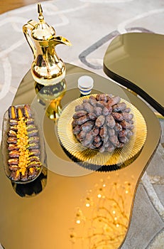 On the table during the holy month of Ramadan, there is a plate with dates, dried fruits and a jug of tea on Iftar in honor of the