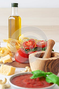 Making tomato pesto, with fresh pasta, parmesan cheese, keshu nuts, basil and olive oil