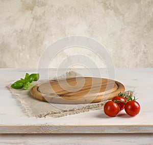 Table and kitchen board over vintage wall background