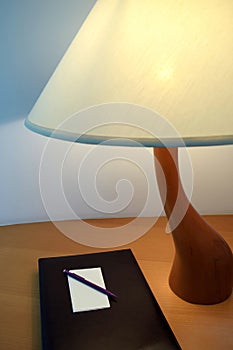 Table Lamp beside the book with Pencil