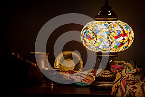 Table lamp of Turkish origin on wooden table and Turkish decoration photo