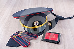 On the table lay a cap, tie straps police lieutenant colonel and a pension certificate AMIA Russia