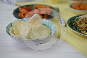 prawn crackers served on a table with traditional Chinese dishes