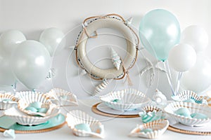 table with life ring wall decor, white and light blue balloons, and shellshaped dishes