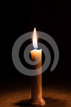 A table lit by a candle in a dark room