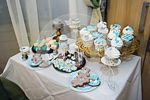 Table with loads of cakes, cupcakes, cookies and cakepops.