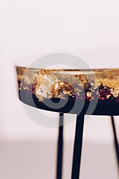 Table made of epoxy resin. Coffee table made of flowers. There is furniture in the room.