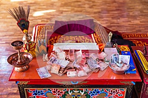Table with money for making merit Inside Guru Rinpoche Temple at Namchi. Sikkim, India