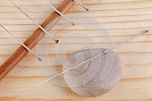 Table with needles for acupuncture. Silver needles for traditional Chinese acupuncture medicine on table. The full depth of cut