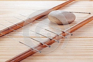 Table with needles for acupuncture. Silver needles for traditional Chinese acupuncture medicine on table. The full depth of cut