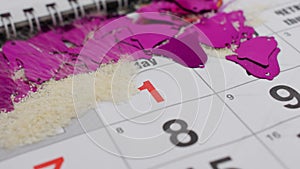On the table is the New Year`s December calendar. The wind blows snow off the calendar and the number appears on January