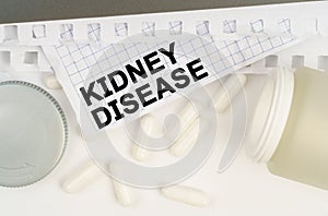 On the table is an open jar of pills and a sheet of paper with the inscription - Kidney Disease