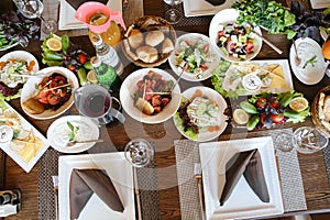 Table Overflowing With Platters of Food and Glasses of Wine