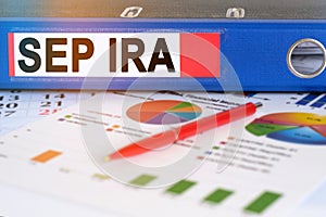 On the table are pie charts, a pen and a folder with the inscription - SEP IRA