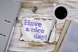 On the table a piece of paper and text. Have a nice day!