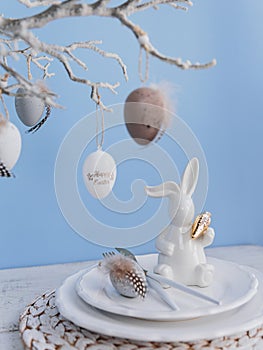 Table place setting with bunny figure and eggs