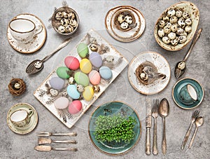 Table place setting with colored eggs. Easter dinner