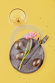 Table place setting, empty glass, Pink tulips and festive easter decor