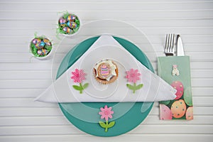 Spring time Easter table place setting with chocolate eggs and cake