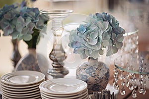 Table with plates stands for candy bar, catering. Golden geometric decorative elements decor. Luxury reception. Setting, setup.