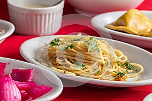 table with platter of Spaghetti Aglio e Olio.