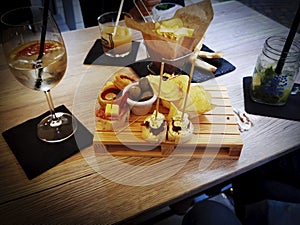 Table with platters of aperitifs with snacks and drinks to drink in a restaurant