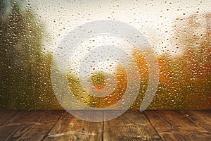 Table on rainy window background