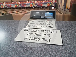 This table reserved and no powder or rosin allowed signs in bowling alley