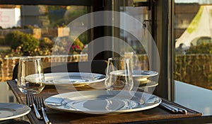 Table in the restaurand served for 2 persons with glasses, plate