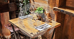 Table in the restaurant with glasses of wine and serving.