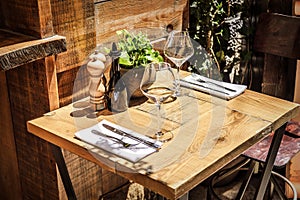 Table in the restaurant in the open air with glasses of wine.