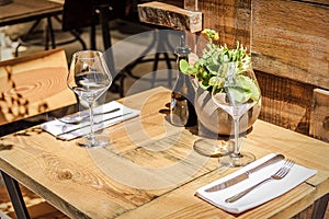 Table in the restaurant in the open air with glasses of wine.