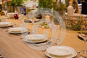 Table in the restaurant served for several persons with glasses and plates