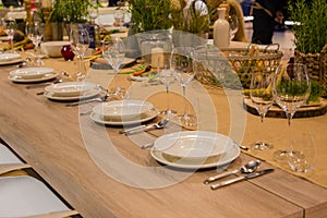 Table in the restaurant served for several persons with glasses and plates
