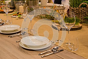 Table in the restaurant served for several persons with glasses and plates