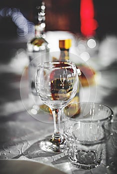 Table in restaurant with white tablecloth and empty glasses