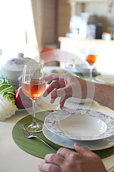 Table with rose wine, fish soup, salad and chiken