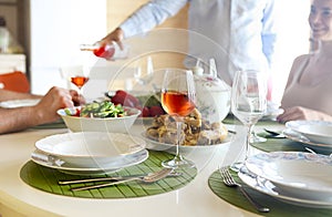 Table with rose wine, fish soup, salad and chiken