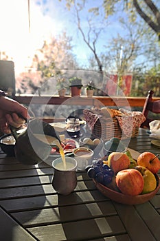 Table In Rustic Wooden Terace full of food and drinks for breakfast