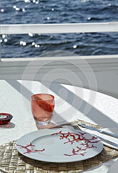 Table on the sea with red glass
