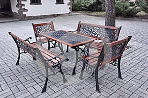 A table and seating around it in an outdoor park