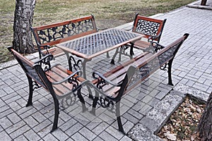 A table and seating around it in an outdoor park