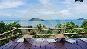 Table and seats on Mountain Top Overlooking sea. Table and chairs, sea on background. Top view form mountains restaurant at Koh