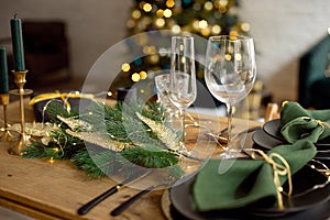 Table served for Christmas dinner in living room, close-up view, table setting, Christmas decoration