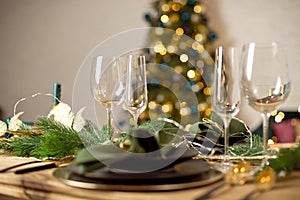 Table served for Christmas dinner in living room, close-up view, table setting, Christmas decoration.